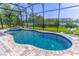Inviting screened-in pool and patio area with a lake view and hot tub at 17840 Passionflower Cir, Clermont, FL 34714