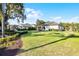 Expansive backyard with lush green lawn, manicured hedges, and the home's exterior in the background at 190 Osprey Hammock Trl, Sanford, FL 32771