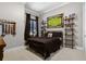 Comfortable bedroom featuring a bed and decor of sports memorabilia at 190 Osprey Hammock Trl, Sanford, FL 32771