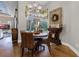 Cozy dining area featuring hardwood floors, stylish woven chairs, and decorative chandelier at 190 Osprey Hammock Trl, Sanford, FL 32771