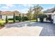Brick driveway with a basketball hoop, landscaping and an exterior view of the house in the background at 190 Osprey Hammock Trl, Sanford, FL 32771