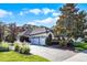 Charming exterior with well-maintained landscaping, a paver driveway, and a three-car garage at 190 Osprey Hammock Trl, Sanford, FL 32771