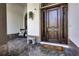 A decorative wood front door with a welcoming entrance and charming porch seating at 190 Osprey Hammock Trl, Sanford, FL 32771