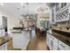 Open kitchen with granite counters, stainless appliances, eat-in kitchen, and views of the Gathering room at 190 Osprey Hammock Trl, Sanford, FL 32771