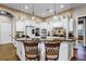 Spacious kitchen featuring granite counters, white cabinets, stainless steel appliances, and breakfast bar with seating at 190 Osprey Hammock Trl, Sanford, FL 32771