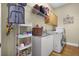 Functional laundry room featuring a utility sink, storage and modern appliances at 190 Osprey Hammock Trl, Sanford, FL 32771
