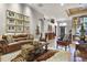 Open-concept living area with a leather sofa, hardwood floors, and tasteful decor at 190 Osprey Hammock Trl, Sanford, FL 32771