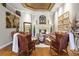 Elegant living room with a fireplace, hardwood floors, and leather furniture at 190 Osprey Hammock Trl, Sanford, FL 32771