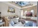 Cozy living room features a decorative ceiling, brick accent wall, comfortable sofa, and TV at 190 Osprey Hammock Trl, Sanford, FL 32771