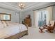 Relaxing main bedroom with a dresser, seating, and windows letting in plenty of natural light at 190 Osprey Hammock Trl, Sanford, FL 32771