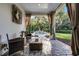 Relaxing covered patio with fire pit, outdoor furniture and views of pool and landscaping at 190 Osprey Hammock Trl, Sanford, FL 32771