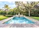 Beautiful rectangular pool with brick surround, fountain feature, and lush landscaping at 190 Osprey Hammock Trl, Sanford, FL 32771