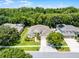 Aerial view of the house featuring its manicured lawn, mature trees, and inviting curb appeal at 2026 Winding Oaks Dr, Orlando, FL 32825
