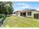 Lush backyard with green grass, a screened lanai and well-maintained fencing providing privacy at 2026 Winding Oaks Dr, Orlando, FL 32825