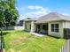 Large backyard featuring a screened lanai and lush grass, ideal for outdoor living and gatherings at 2026 Winding Oaks Dr, Orlando, FL 32825