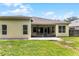 Expansive backyard featuring a brick patio and a screened lanai, perfect for outdoor entertaining and relaxation at 2026 Winding Oaks Dr, Orlando, FL 32825