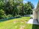 Spacious backyard with a green lawn and perimeter fence, offering plenty of room for outdoor activities at 2026 Winding Oaks Dr, Orlando, FL 32825
