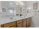 Bathroom with double sinks, a vanity, a large mirror, and updated fixtures at 2026 Winding Oaks Dr, Orlando, FL 32825