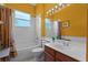 Bright bathroom featuring vanity sink, toilet, and bathtub with shower at 2026 Winding Oaks Dr, Orlando, FL 32825