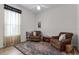 Cozy bedroom featuring two armchairs, ceiling fan, and area rug at 2026 Winding Oaks Dr, Orlando, FL 32825