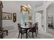 Elegant dining room with neutral color scheme, large window, and a view of the foyer at 2026 Winding Oaks Dr, Orlando, FL 32825