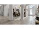 Open-concept dining room with neutral paint, light tile flooring, and a view to the foyer at 2026 Winding Oaks Dr, Orlando, FL 32825