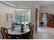 Bright dining room featuring a glass table and view of the screened-in patio at 2026 Winding Oaks Dr, Orlando, FL 32825