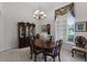 Traditional dining room with elegant chandelier, large window, china cabinet, and seating for six at 2026 Winding Oaks Dr, Orlando, FL 32825