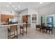 Bright kitchen with breakfast bar, tile flooring, and dining nook with a view at 2026 Winding Oaks Dr, Orlando, FL 32825