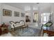 Bright living room with elegant furniture, a decorative rug, and views into the dining room at 2026 Winding Oaks Dr, Orlando, FL 32825