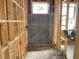Unfinished bathroom framework and space, with studs and a window above the shower area at 2371 Zuni Road, St Cloud, FL 34771