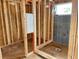 Framed bathroom featuring a tiled shower wall with installed plumbing fixtures and a window at 2371 Zuni Road, St Cloud, FL 34771