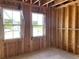Bare bedroom space with two windows, unfinished walls, wiring, and concrete floor at 2371 Zuni Road, St Cloud, FL 34771