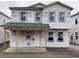 Unfinished two-story home featuring a covered porch and large windows awaiting customization at 2371 Zuni Road, St Cloud, FL 34771