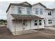 An incomplete two-story home with a porch and large windows is awaiting final touches at 2371 Zuni Road, St Cloud, FL 34771
