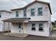 Under-construction two-story home featuring a porch and expansive windows in a growing neighborhood at 2371 Zuni Road, St Cloud, FL 34771