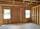 The unfinished living room has windows and exposed framing, awaiting customization at 2371 Zuni Road, St Cloud, FL 34771