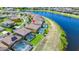 An aerial view shows backyard pools in a vibrant community near a peaceful lake at 2209 Crofton Ave, Davenport, FL 33837