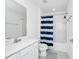 Clean bathroom featuring a shower-tub combination with white and blue curtain at 2209 Crofton Ave, Davenport, FL 33837