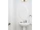 A pedestal sink in a modern bathroom with a decorative mirror and fixtures at 2209 Crofton Ave, Davenport, FL 33837