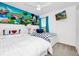 bedroom with colorful Disney decor and white furniture at 2209 Crofton Ave, Davenport, FL 33837