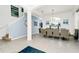 Spacious dining area with a large white table, modern chairs, and elegant decor with blue accents at 2209 Crofton Ave, Davenport, FL 33837