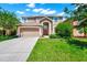 Charming two-story home with a well-manicured lawn and inviting curb appeal on a beautiful day at 2209 Crofton Ave, Davenport, FL 33837