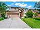 Charming two-story home with a well-manicured lawn and inviting curb appeal on a beautiful day at 2209 Crofton Ave, Davenport, FL 33837
