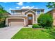 Charming two-story home with a well-manicured lawn and inviting curb appeal on a beautiful day at 2209 Crofton Ave, Davenport, FL 33837