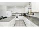 Bright kitchen featuring white cabinetry, granite countertops, and stainless steel appliances at 2209 Crofton Ave, Davenport, FL 33837