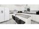 Bright kitchen featuring white cabinetry, granite countertops, and stainless steel appliances at 2209 Crofton Ave, Davenport, FL 33837