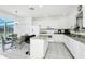 Bright kitchen featuring white cabinetry, granite countertops, and stainless steel appliances at 2209 Crofton Ave, Davenport, FL 33837