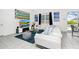 Modern living room with a white sectional sofa, flat-screen TV, stylish decor, and access to outdoor area at 2209 Crofton Ave, Davenport, FL 33837