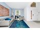 Inviting living area with light blue walls, modern sofas, a striking rug, and a bright front door at 2209 Crofton Ave, Davenport, FL 33837